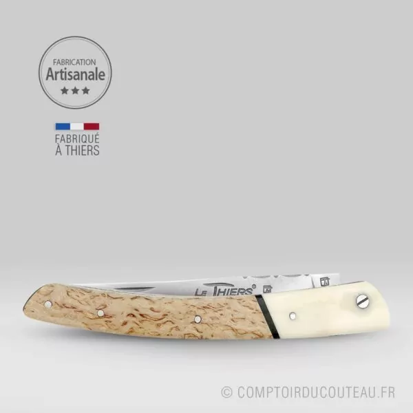 couteau le thiers prestige bi-matières manche en bouleau de finlande et dent phacochère, lame et ressort guilloches