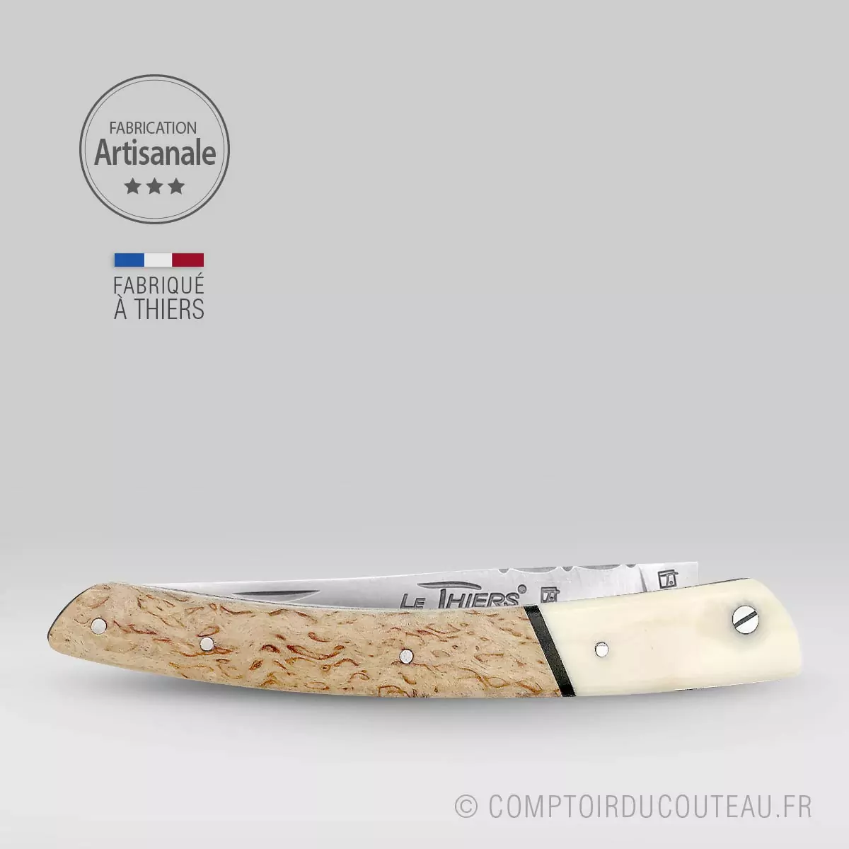 couteau le thiers prestige bi-matières manche en bouleau de finlande et dent phacochère, lame et ressort guilloches